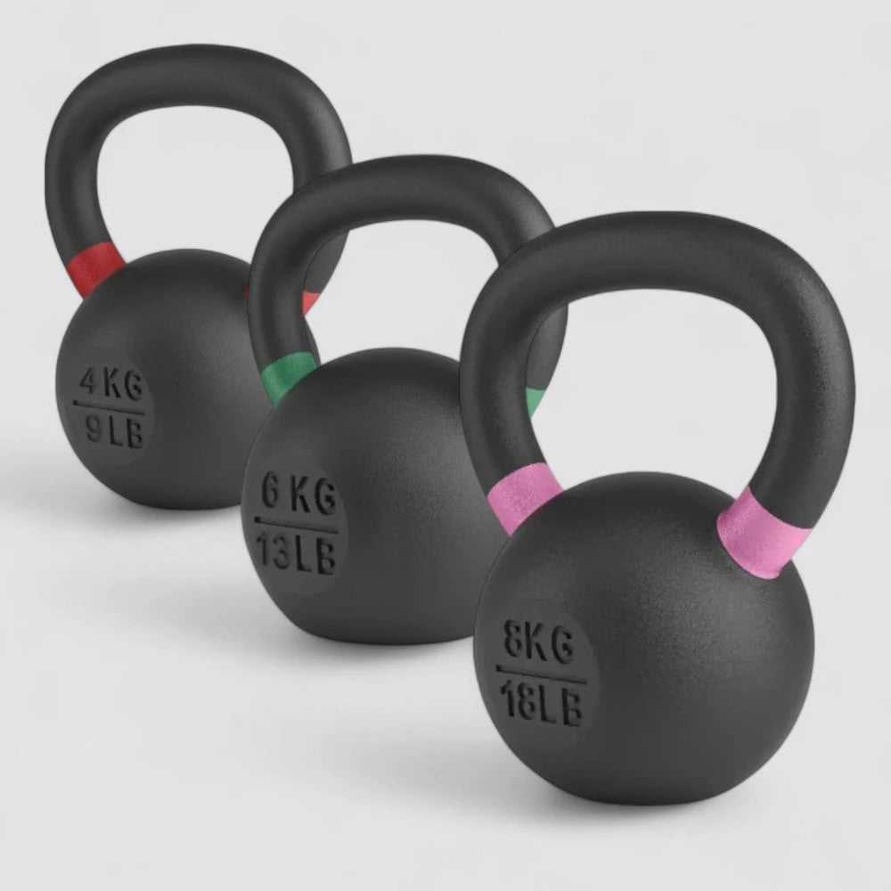 Three black kettlebells with weight markings on a light gray background
