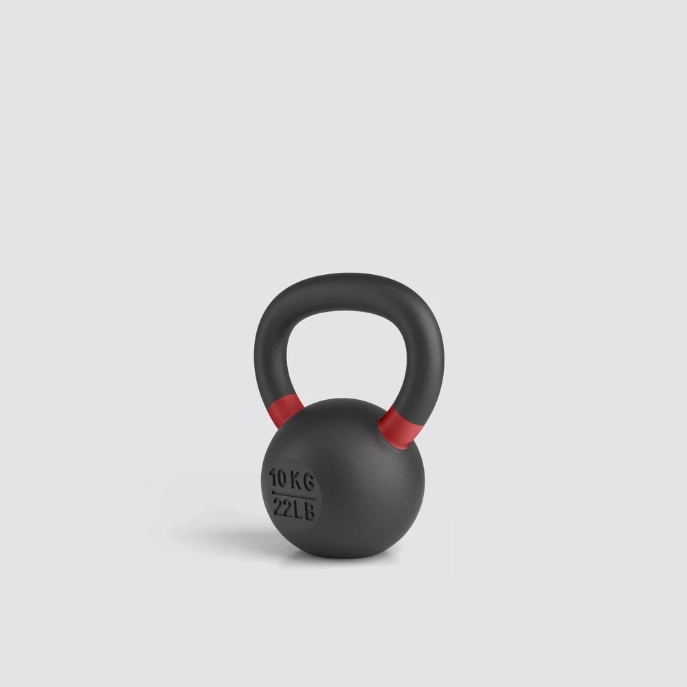 Black kettlebell with red accents on a light gray background