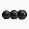 Three black exercise balls with weight labels on a white background