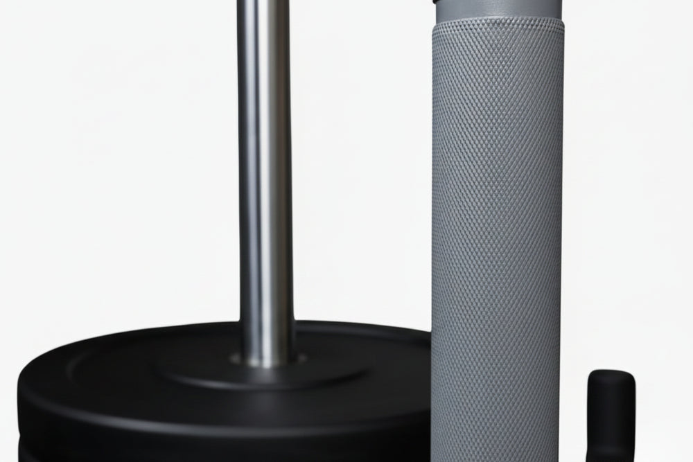 Close-up of weight plates loaded onto a power sled with textured anti slip grips on a white background