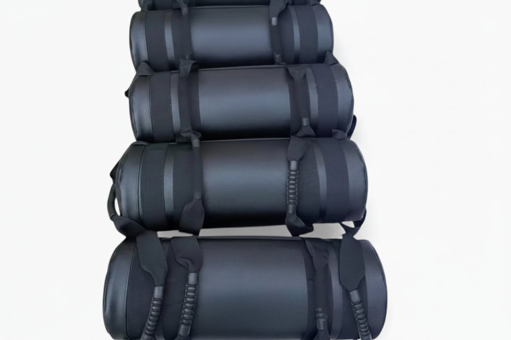 Stack of black gym sand bags on a white background