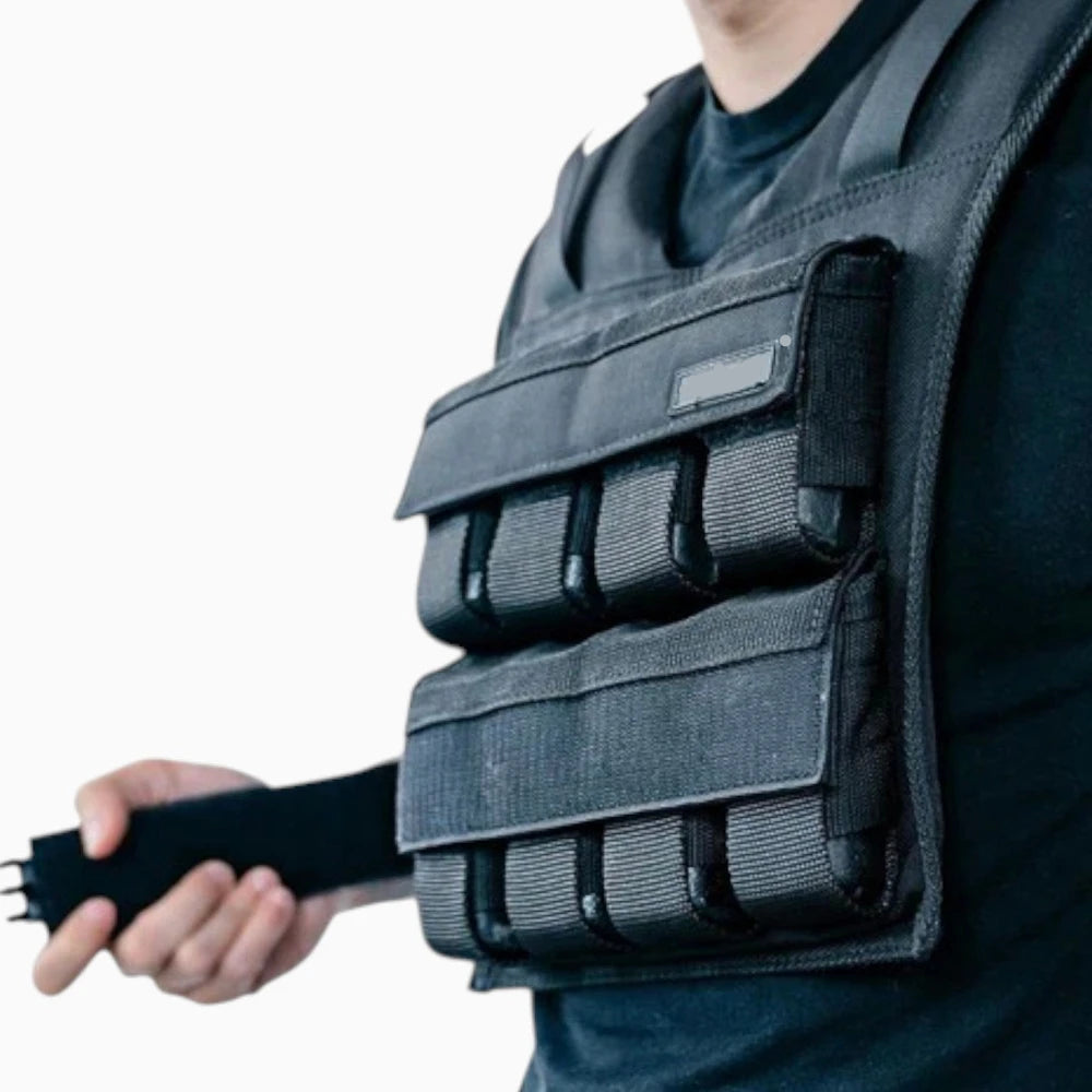 Person wearing a black weighted vest on a white background