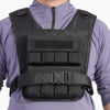 Person wearing a black weight vest on a white background