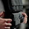 Person adjusting a black weight gym vest