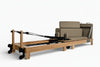 Pilates reformer with a wooden frame on a white background
