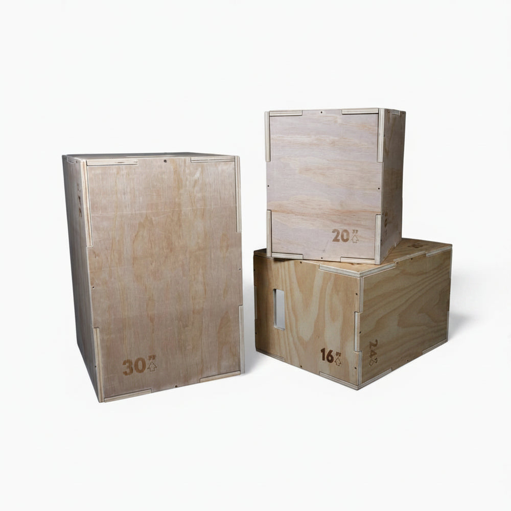 Three wooden jump boxes of different sizes stacked on a white background