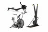 Three pieces of exercise equipment on a white background: a rowing machine, an air bike, and a ski eg