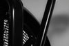 Close-up of a black exercise bike on a blurred background