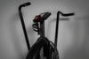 Black exercise bike with handlebars on a gray background