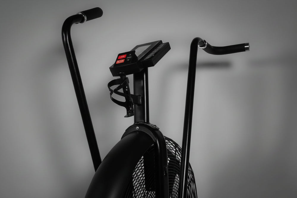 Black exercise bike with handlebars on a gray background
