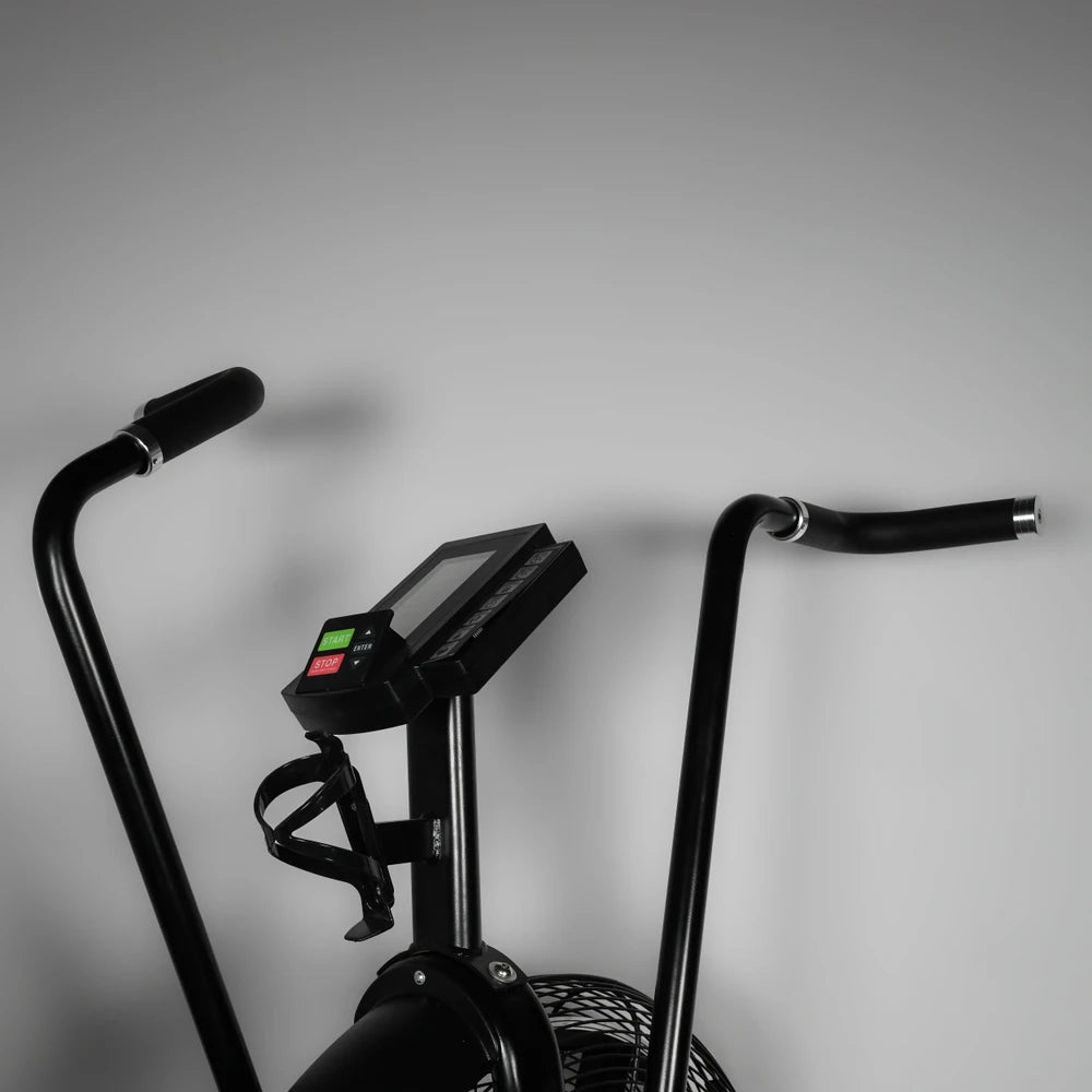 Black exercise bike with handlebars and control panel on a gray background