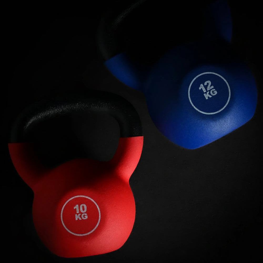 Red and blue kettlebells with weight labels on a black background
