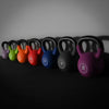 Row of colorful kettlebells on a dark background