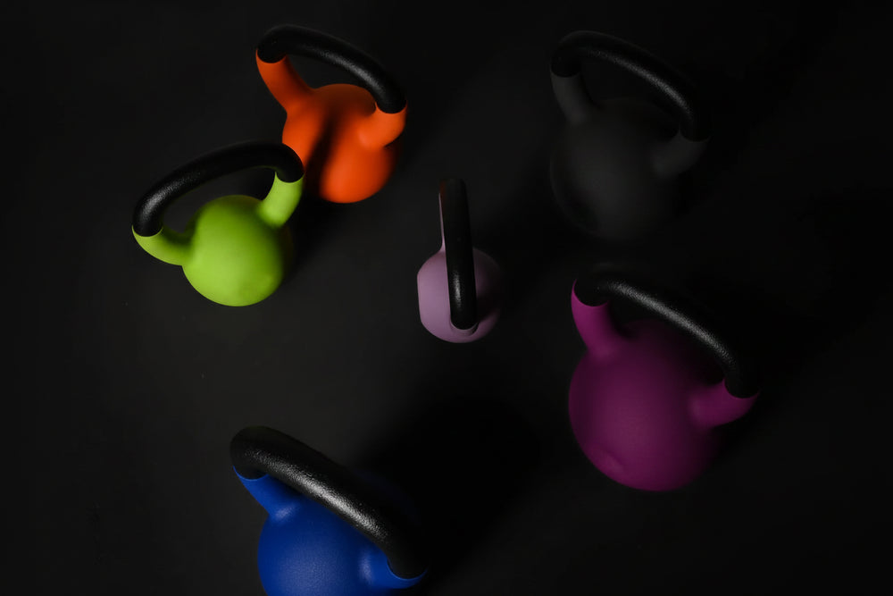 Colorful kettlebells on a black background