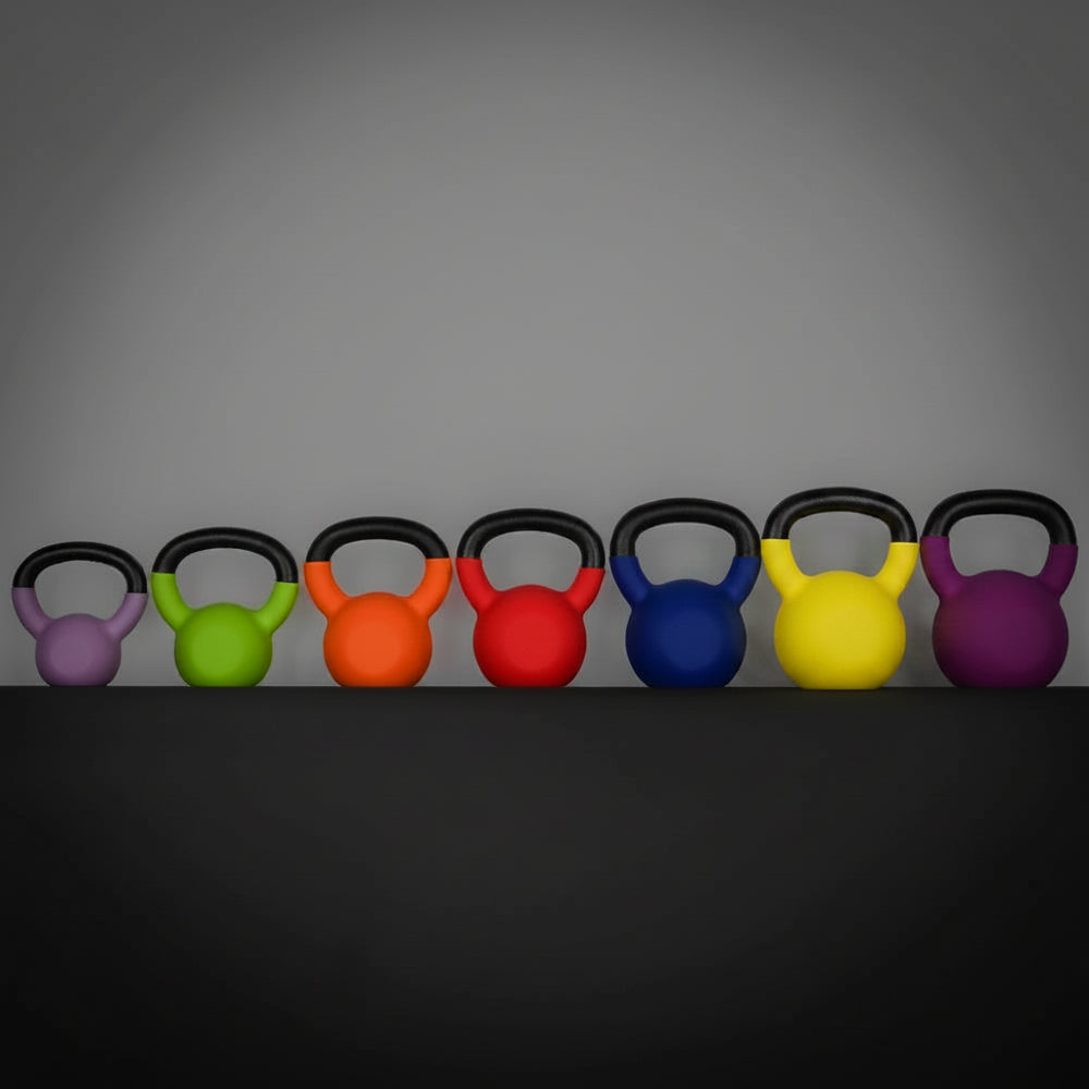 Row of colorful kettlebells on a dark surface with a gray background