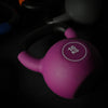 Purple dumbbell with '16 KG' label on a dark background