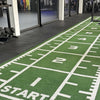 Commercial power sled mat in a gym setting with white measurement markings