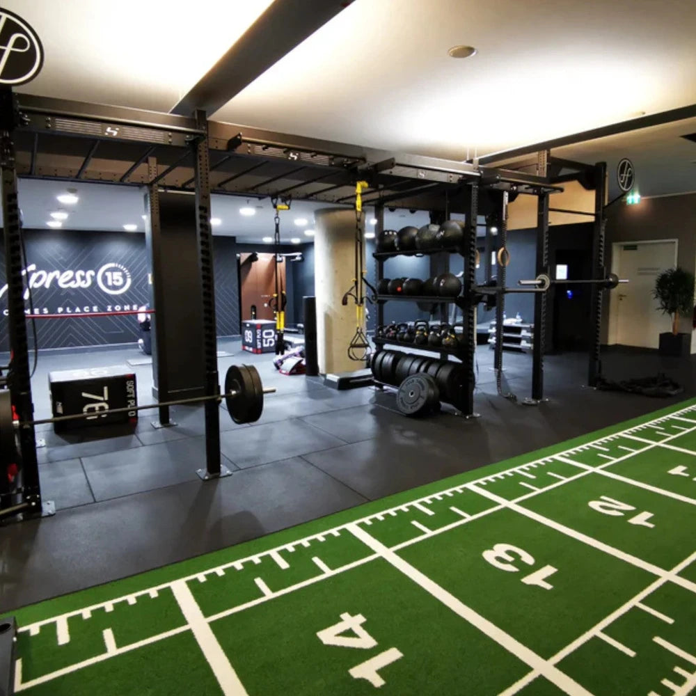 Gym interior with power sled flooring mat in a commercial gym setting