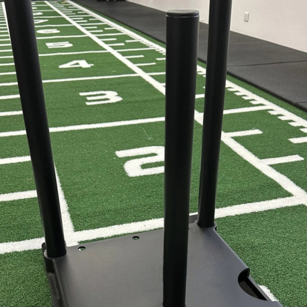Power sled on a sledge training mat with clear white markings