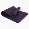 Purple yoga mat on a white background