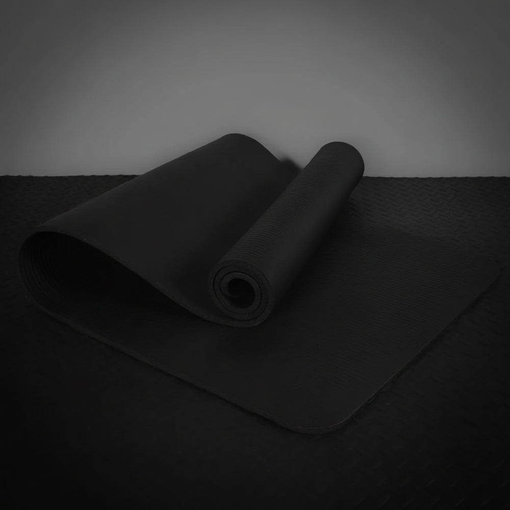 Black exercise mat on a dark surface