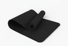 Black yoga mat on a white background