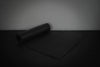 Black exercise mat on a dark surface