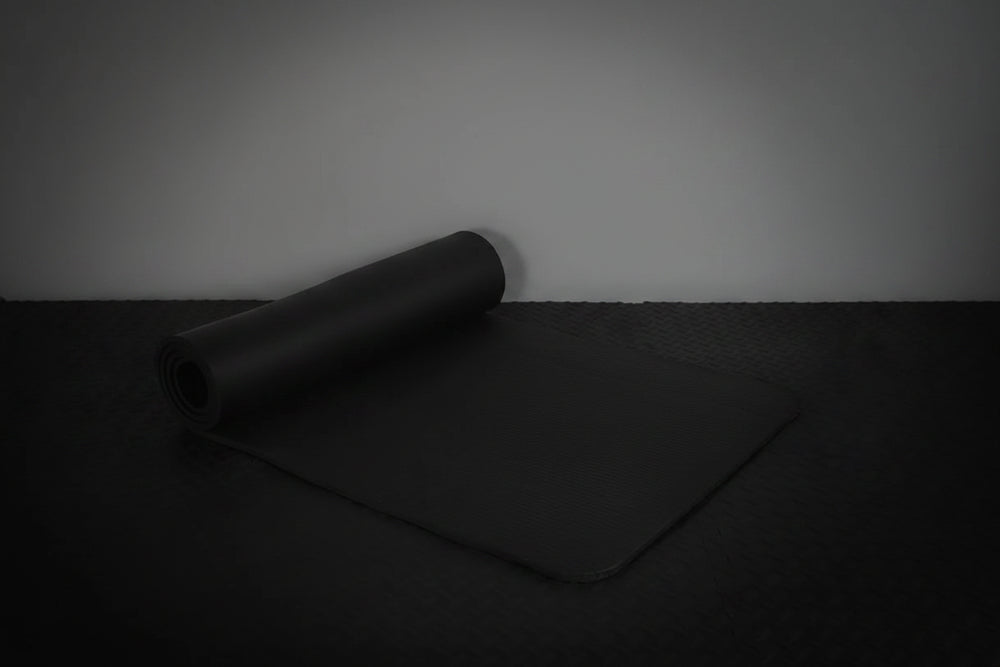 Black exercise mat on a dark surface