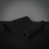 Black yoga mat on a dark surface
