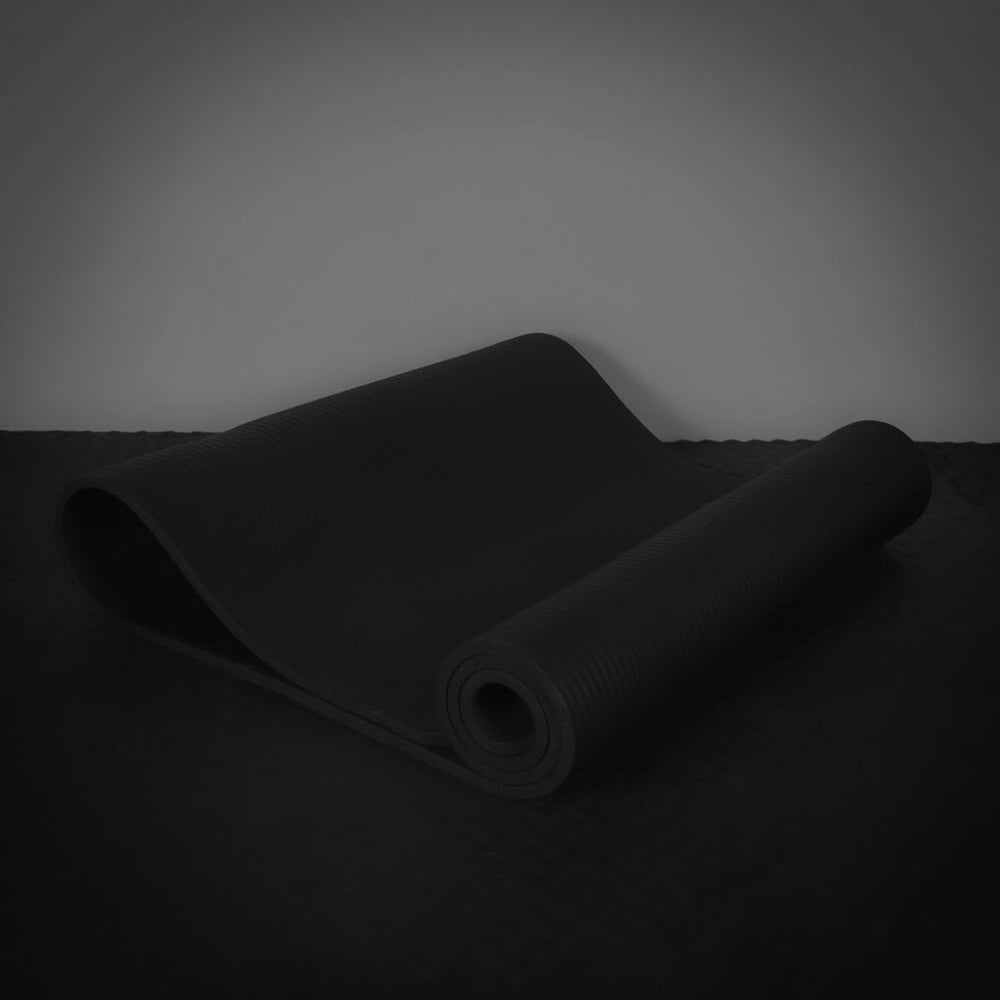 Black yoga mat on a dark surface