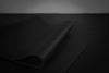 Black yoga mat on a dark background