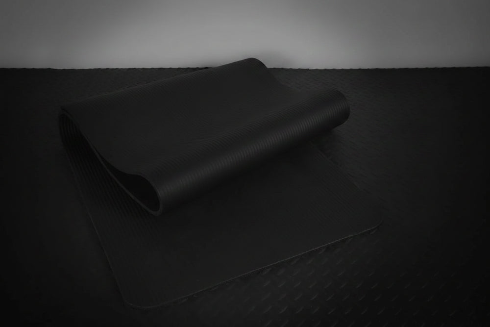 Black gym mat on a dark background