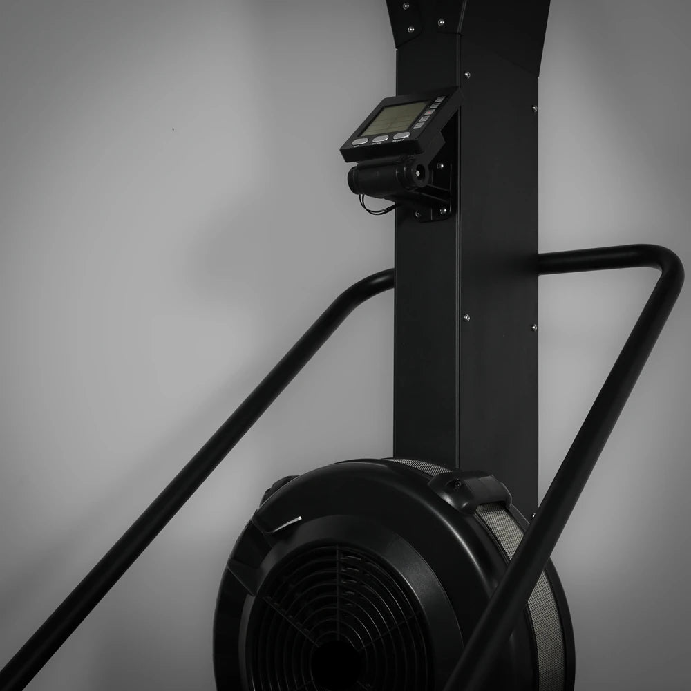 Black exercise ski erg with digital display on a gray background