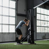 Person using a black ski erg exercise machine in a gym setting