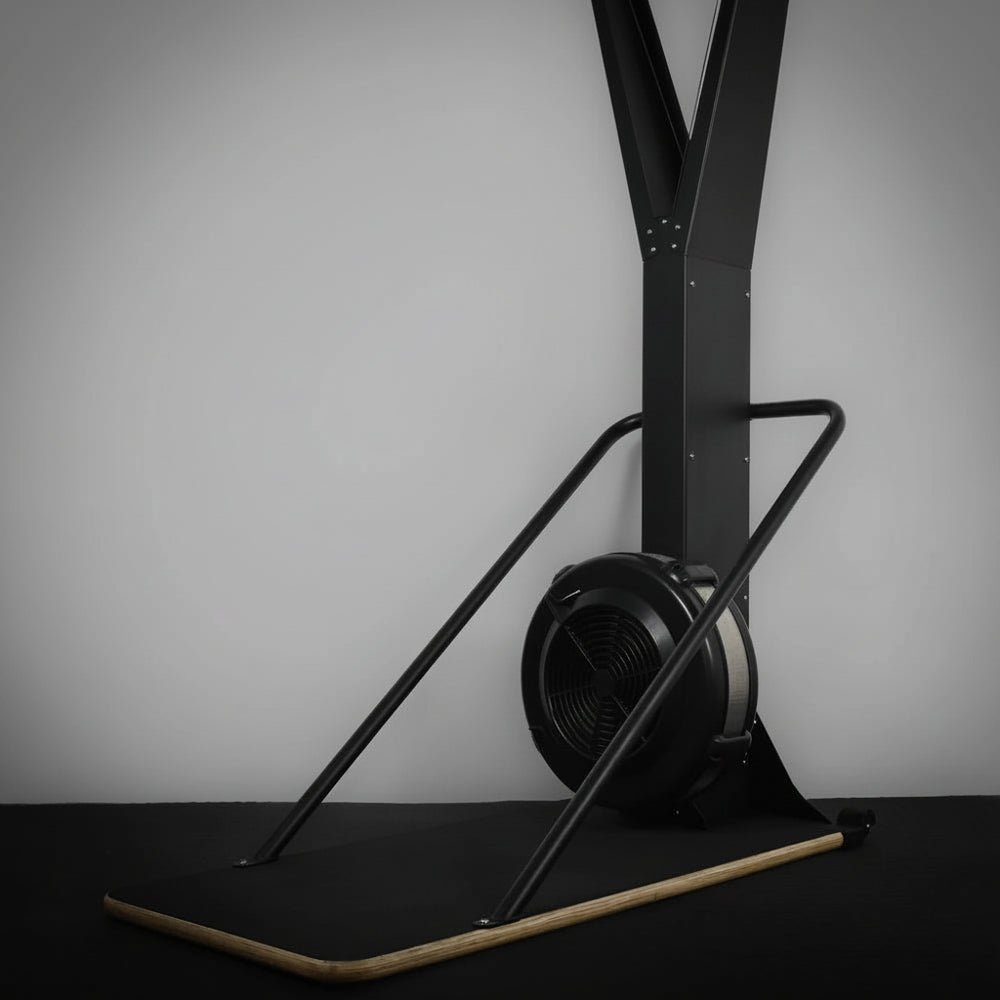 Black exercise ski erg with digital display on a gray background