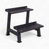 Black weights rack on a white background