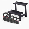 Set of black kettlebells with a black metal step platform on a white background
