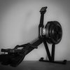 Rowing machine with digital display on a gray background