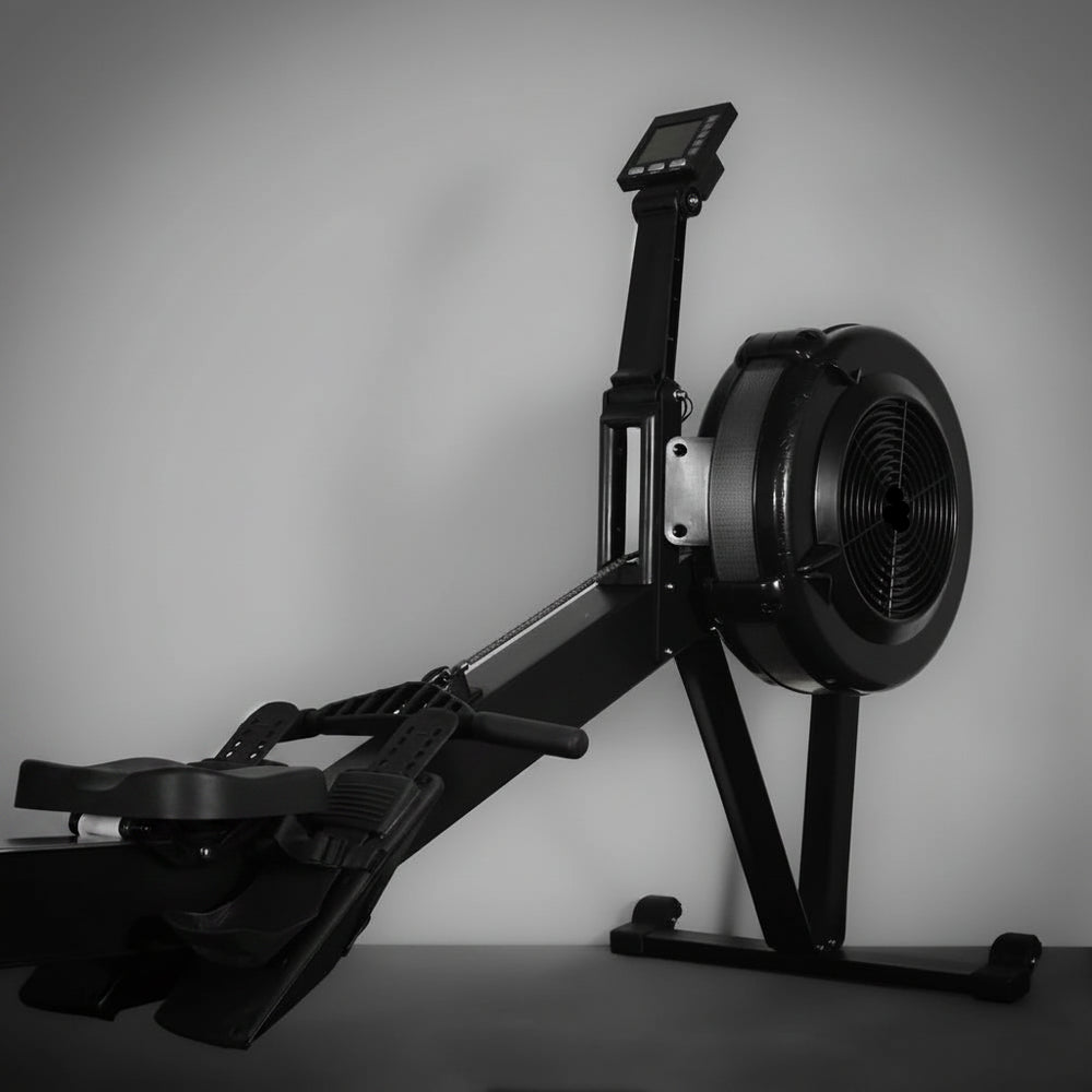 Rowing machine with digital display on a gray background