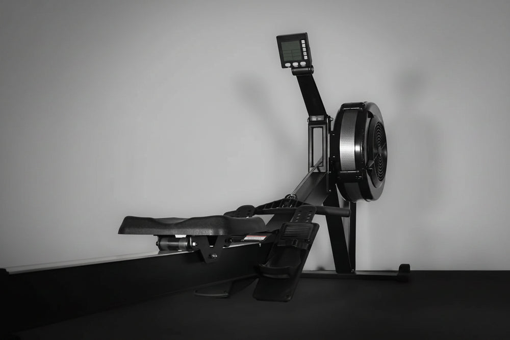 Rowing machine with digital display on a gray background
