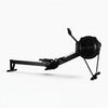 Black rowing erg machine on a white background