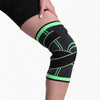 Black and green knee brace on a person's knee against a white background