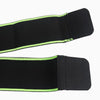 Black knee brace straps with green trim on a white background