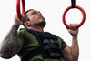 Man performing pull-ups with a weight vest on a white background