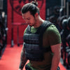 Man wearing a weighted vest in a gym setting