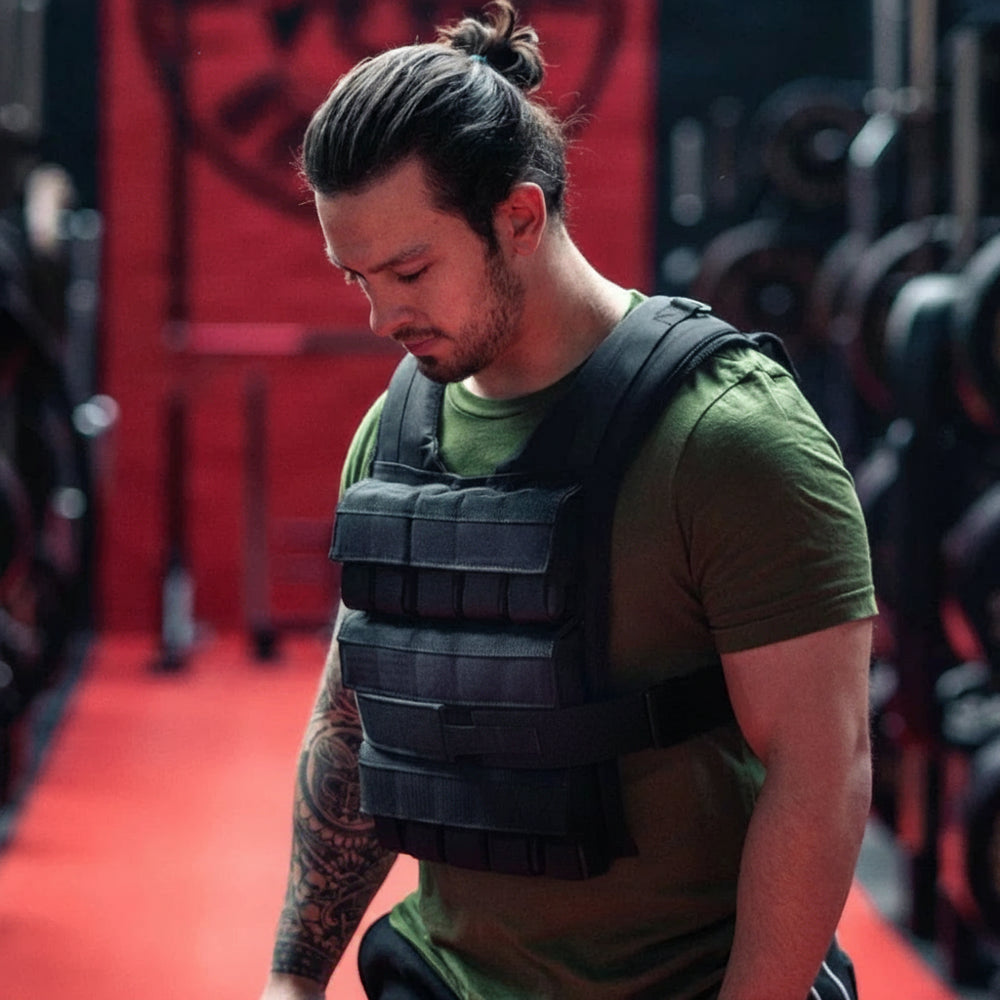 Man wearing a weighted vest in a gym setting