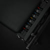 Close-up of mechanism on a pilates reformer machine on a dark background