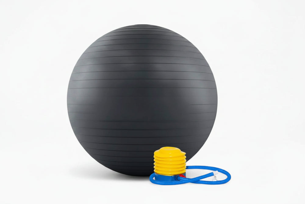 Black exercise ball with pump and resistance bands on a white background