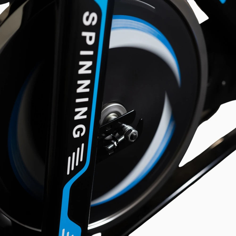 Close-up of a spinning bike wheel with 'Spinning' branding on a white background