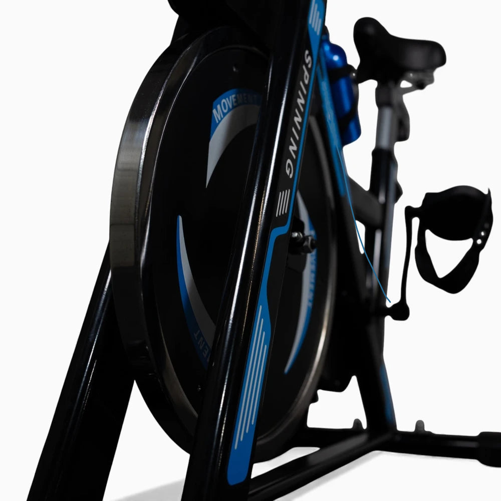 Close-up of a black and blue exercise bike on a white background